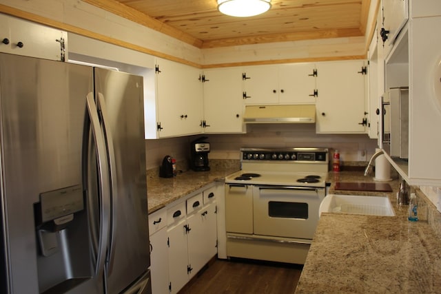 kitchen featuring stainless steel refrigerator with ice dispenser, white cabinetry, light stone counters, and range with two ovens