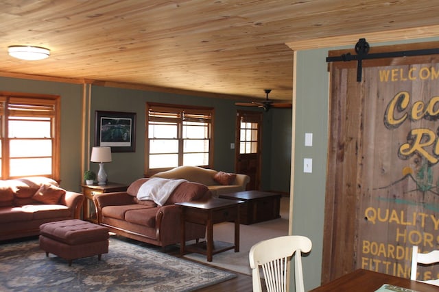 living room with wood ceiling, ornamental molding, and a barn door