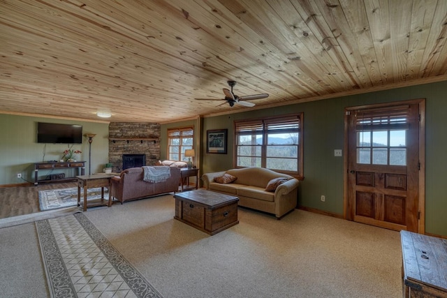 living room featuring crown molding, ceiling fan, a fireplace, and wooden ceiling