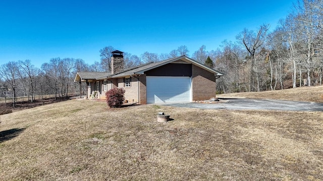 view of side of home with a garage and a lawn