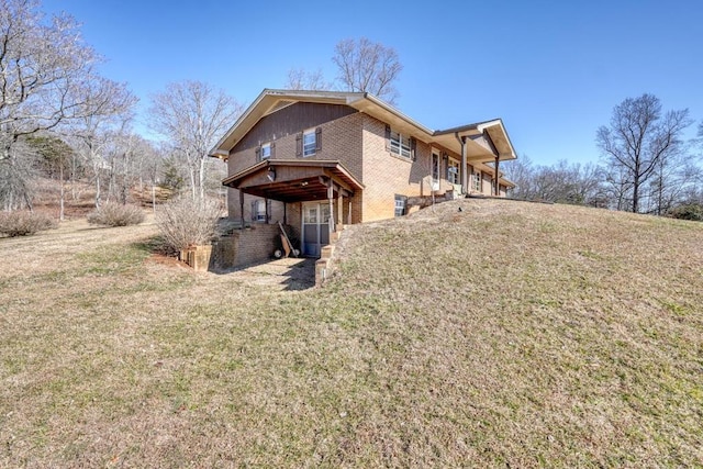 rear view of house featuring a lawn