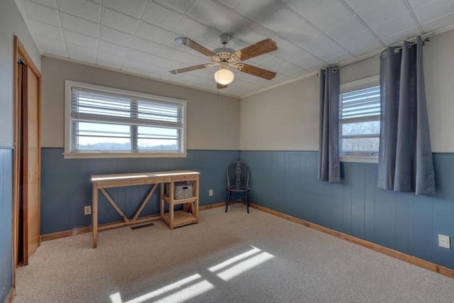 empty room with ceiling fan and carpet flooring