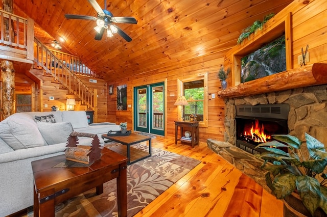 living room with wood walls, wood-type flooring, vaulted ceiling, wooden ceiling, and a fireplace