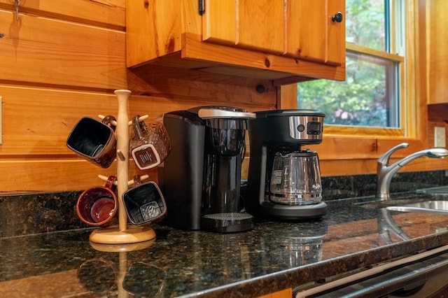 room details with sink, dark stone counters, and dishwasher