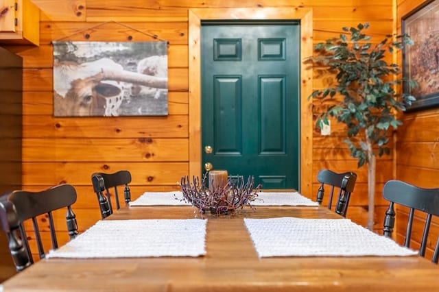 dining room featuring wood walls