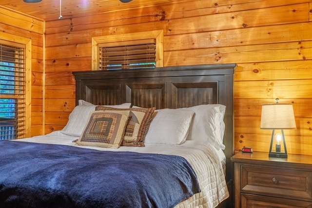 bedroom featuring wooden walls