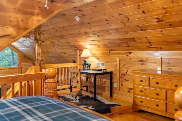 bedroom with vaulted ceiling, wood-type flooring, and wood walls