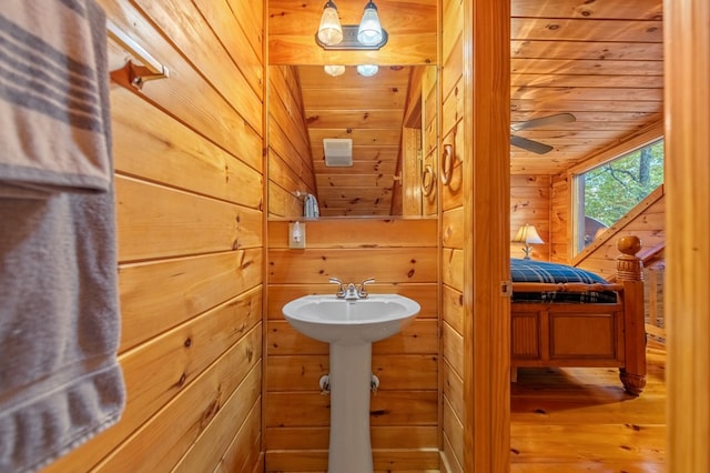 bathroom with wooden walls, wooden ceiling, and wood-type flooring