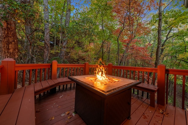 wooden terrace with a fire pit