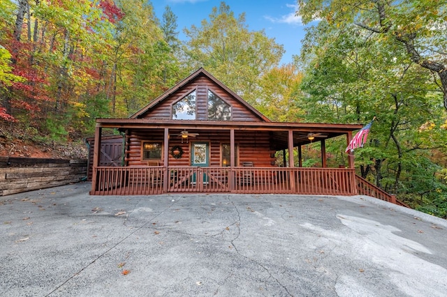 log-style house featuring covered porch