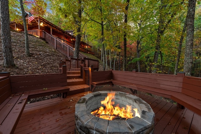 wooden deck with an outdoor fire pit