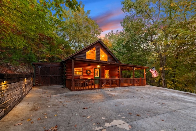 property exterior at dusk featuring a porch