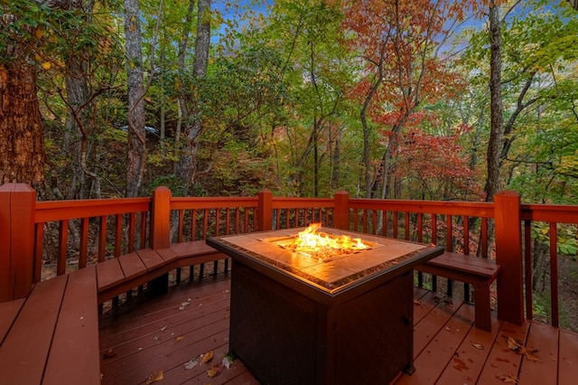 wooden deck featuring a fire pit