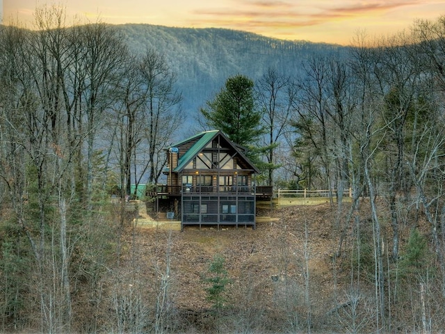 back house at dusk with a mountain view