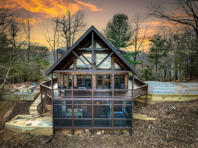 view of back house at dusk