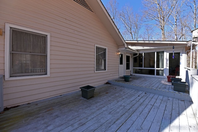 wooden deck with a sunroom