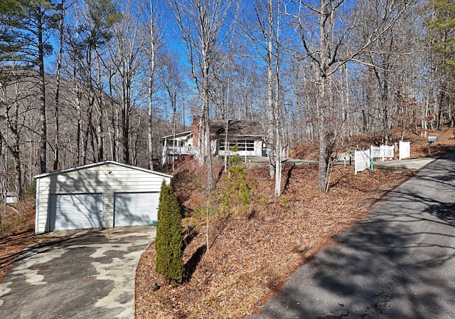 view of front of property with a garage and an outbuilding