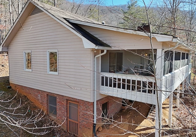 view of home's exterior with a sunroom