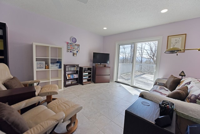 tiled living room featuring a textured ceiling