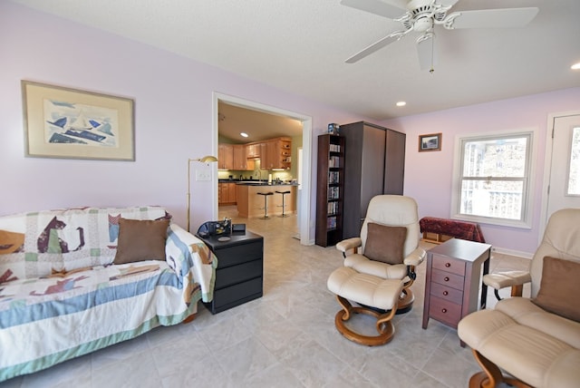 living room featuring a textured ceiling and ceiling fan