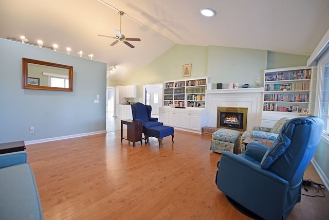 living room featuring hardwood / wood-style flooring, high vaulted ceiling, and ceiling fan