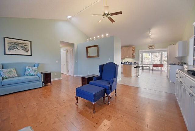 living room featuring high vaulted ceiling, light hardwood / wood-style floors, and ceiling fan