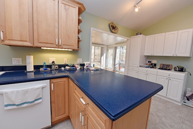 kitchen featuring track lighting, a textured ceiling, light brown cabinetry, vaulted ceiling, and kitchen peninsula