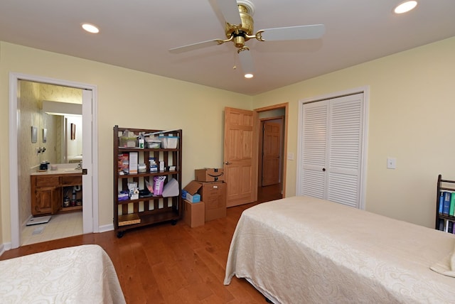 bedroom featuring hardwood / wood-style flooring, ensuite bathroom, ceiling fan, and a closet