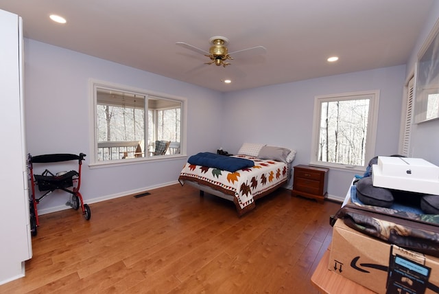 bedroom with ceiling fan and wood-type flooring