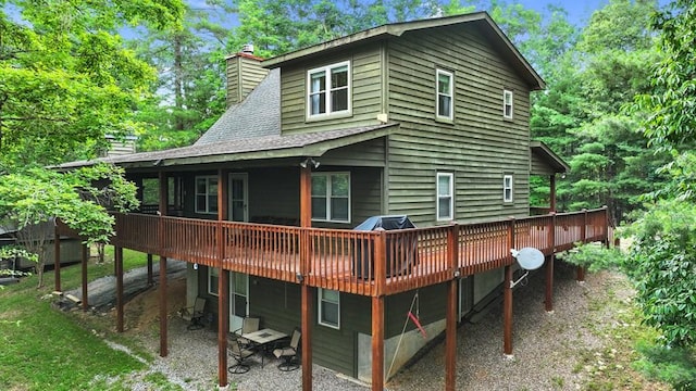 back of house with a wooden deck