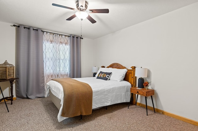 carpeted bedroom with a textured ceiling and ceiling fan