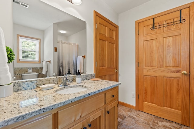 bathroom featuring vanity and toilet