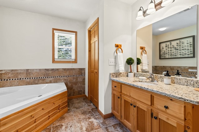 bathroom featuring vanity and a tub