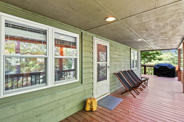 wooden deck featuring a grill