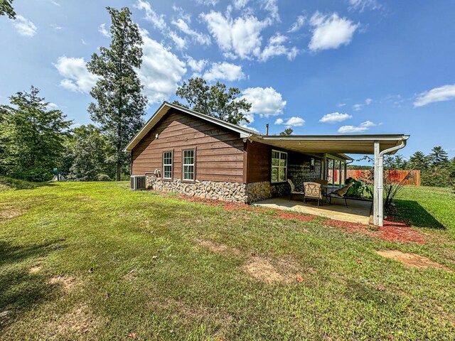 exterior space with a yard, central AC unit, and a patio