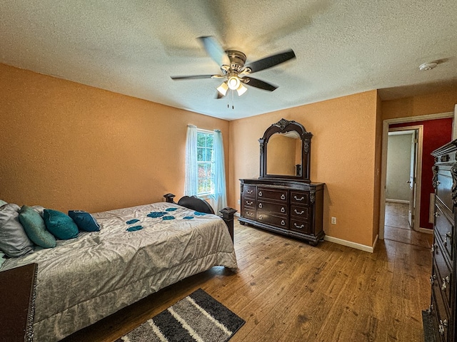 bedroom featuring a textured ceiling, ceiling fan, and hardwood / wood-style flooring