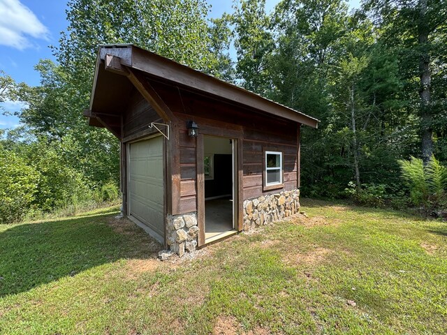 view of outbuilding featuring a yard and a garage