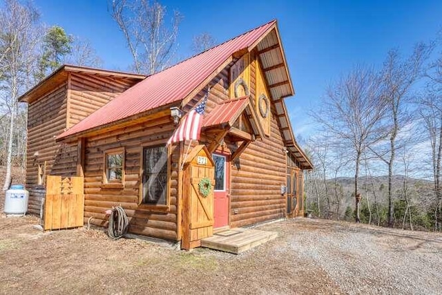 rear view of property with metal roof