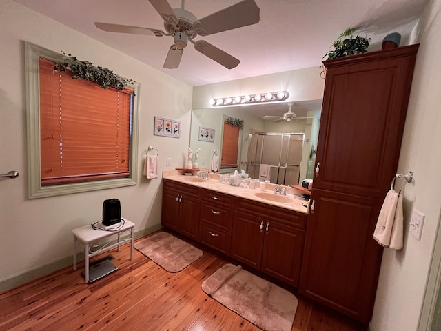 199 Orlon Dr, East Ellijay, GA 30540 - bathroom with hardwood / wood-style floors, double vanity, a shower stall, a ceiling fan, and baseboards