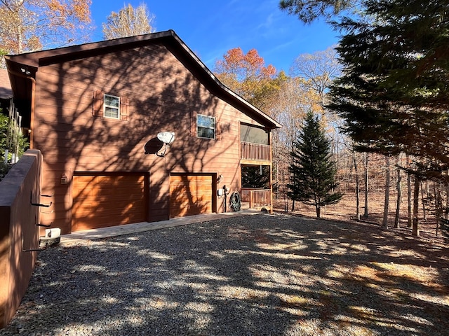 199 Orlon Dr, East Ellijay, GA 30540 - view of home's exterior featuring an attached garage, driveway, and a balcony