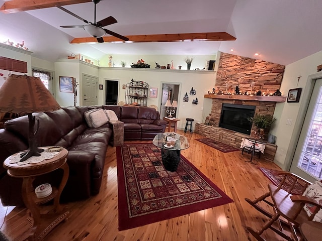 living room with vaulted ceiling with beams, ceiling fan, a healthy amount of sunlight, and hardwood / wood-style flooring