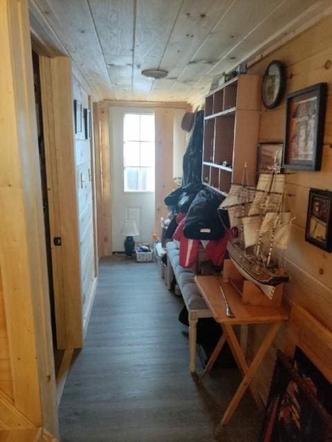 mudroom featuring wood-type flooring and wood walls