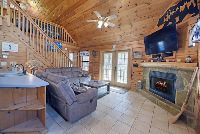 living room with sink, wood walls, wood ceiling, and light tile patterned flooring