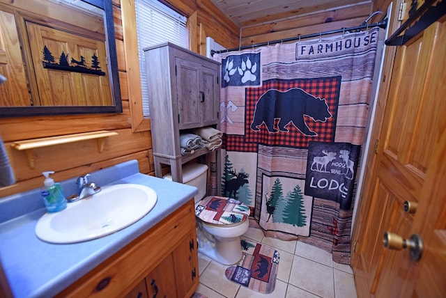 bathroom with toilet, vanity, tile patterned floors, wood walls, and a shower with shower curtain