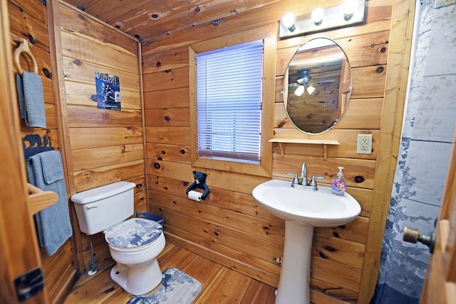 bathroom featuring toilet, wood-type flooring, wood ceiling, and wooden walls