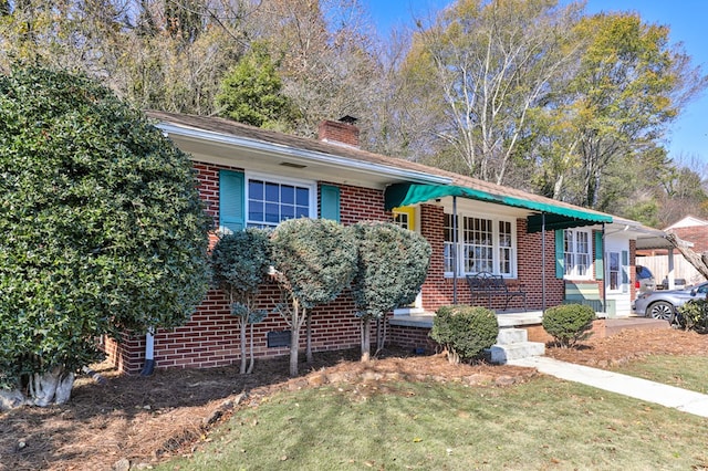 ranch-style house with a front lawn and covered porch