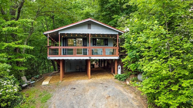 338 Canter Ct, Ellijay, GA 30540 - view of front facade featuring dirt driveway, a carport, and a wooded view