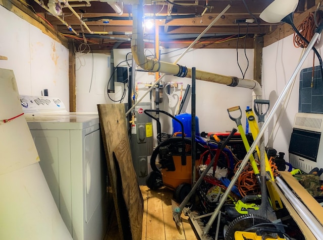 338 Canter Ct, Ellijay, GA 30540 - unfinished below grade area featuring heating unit, wood finished floors, washing machine and clothes dryer, and hybrid water heater
