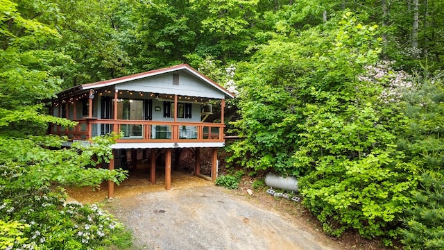 338 Canter Ct, Ellijay, GA 30540 - view of front of house featuring driveway, a carport, and a wooded view