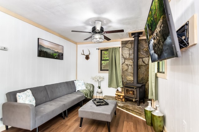 338 Canter Ct, Ellijay, GA 30540 - living room with a wood stove, wood finished floors, a ceiling fan, baseboards, and ornamental molding